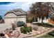 Inviting exterior view showcasing the stone accents, manicured landscaping, and well-maintained front yard at 11302 Mesa Verde Pl, Parker, CO 80138