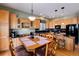 View of the kitchen and dining area with modern appliances and a breakfast bar at 11302 Mesa Verde Pl, Parker, CO 80138