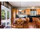 Kitchen boasts wood cabinets, black countertops, wood floors, and an adjacent dining area at 11302 Mesa Verde Pl, Parker, CO 80138