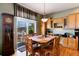 Open-concept kitchen and dining area with wood floors, and a sliding door to outdoor space at 11302 Mesa Verde Pl, Parker, CO 80138