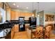A kitchen showcasing wood cabinets, black appliances, stone countertops, and a central island at 11302 Mesa Verde Pl, Parker, CO 80138