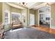 Spacious living room showcasing a bay window, hardwood floors, and an open doorway into a room with built-in shelves at 11302 Mesa Verde Pl, Parker, CO 80138