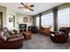 The living room with large windows offers natural light and inviting seating around the fireplace at 11302 Mesa Verde Pl, Parker, CO 80138