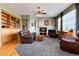 A living room features a fireplace, built-in shelves, and a cozy seating arrangement at 11302 Mesa Verde Pl, Parker, CO 80138