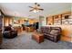 An inviting living room and kitchen featuring wood cabinetry and a fireplace at 11302 Mesa Verde Pl, Parker, CO 80138