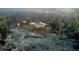 Aerial view of the property nestled in a forest covered in the snow and frost during the winter at 8 Sioux Trl, Evergreen, CO 80439