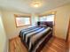 Cozy bedroom featuring hardwood floors, natural light, and a closet at 8 Sioux Trl, Evergreen, CO 80439