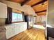 Bright kitchen with white cabinets, stainless steel refrigerator, and mountain views at 8 Sioux Trl, Evergreen, CO 80439