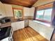 Well-lit kitchen with stainless steel appliances, white cabinets, and scenic mountain views at 8 Sioux Trl, Evergreen, CO 80439