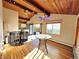 Sunlit living room with hardwood floors, vaulted ceilings, and deck access with mountain views at 8 Sioux Trl, Evergreen, CO 80439