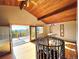 Bright living room with wooden floors, vaulted ceilings and deck access with stunning views at 8 Sioux Trl, Evergreen, CO 80439
