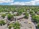 An aerial view shows a community surrounded by green trees and convenient parking areas at 5300 E Cherry Creek South Drive # 918, Denver, CO 80246