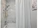 A bathroom featuring a shower and tub with new tile and modern fixtures at 5300 E Cherry Creek South Drive # 918, Denver, CO 80246