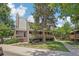 A view of a townhome exterior with mature trees, green space and a sidewalk at 5300 E Cherry Creek South Drive # 918, Denver, CO 80246