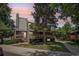 Multi-level home featuring a chimney and a small porch with natural landscaping at 5300 E Cherry Creek South Drive # 918, Denver, CO 80246