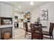 Kitchen and dining room combo with stainless appliances, white cabinetry and stylish decor at 5300 E Cherry Creek South Drive # 918, Denver, CO 80246