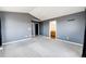 Spacious main bedroom featuring neutral carpeting, gray walls, and ensuite bathroom access at 604 S Norfolk Way, Aurora, CO 80017