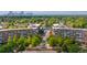 Ariel view with city skyline over the trees and multi-story brick buildings at 7700 E 29 Ave # 304, Denver, CO 80238