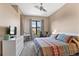 Comfortable bedroom with a large window offering natural light and city views at 7700 E 29 Ave # 304, Denver, CO 80238