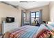 Comfortable bedroom with a large window offering natural light and city views at 7700 E 29 Ave # 304, Denver, CO 80238