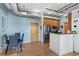 Dining area adjacent to kitchen with modern table and chairs and exposed ductwork at 7700 E 29 Ave # 304, Denver, CO 80238