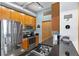 This bright kitchen offers stainless steel appliances, wood cabinets, black countertops, and a stainless steel sink at 7700 E 29 Ave # 304, Denver, CO 80238
