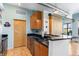 Well-equipped kitchen with stainless steel appliances, granite countertops, and adjacent island with sink at 7700 E 29 Ave # 304, Denver, CO 80238