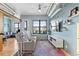 Bright living room featuring modern furnishings, exposed ductwork, light blue walls, and a large window at 7700 E 29 Ave # 304, Denver, CO 80238