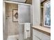 Bathroom features a large shower with neutral tile, a shower head, glass door and accent tile at 11488 E Amherst S Cir, Aurora, CO 80014