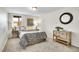 Bedroom features neutral carpet, a double bed, a night stand and wooden dresser with a round mirror at 11488 E Amherst S Cir, Aurora, CO 80014