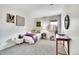 Bedroom features neutral carpet, a window with a wooded view, and two art pieces on the walls at 11488 E Amherst S Cir, Aurora, CO 80014