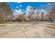 Community building with ample parking, mature trees, and nearby recreational facilities at 11488 E Amherst S Cir, Aurora, CO 80014