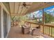 Comfortable covered patio with wicker furniture, wood decking, and a ceiling fan for relaxation at 11488 E Amherst S Cir, Aurora, CO 80014