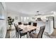 Cozy dining area with a wooden table, six chairs, and easy access to the kitchen and backyard at 11488 E Amherst S Cir, Aurora, CO 80014