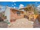 Back exterior view showcasing the brick siding and wood deck with stairs to the back yard at 11488 E Amherst S Cir, Aurora, CO 80014