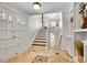 Bright foyer with tiled flooring, a staircase leading upstairs, and a coat closet at 11488 E Amherst S Cir, Aurora, CO 80014