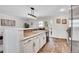Bright, functional kitchen featuring tiled countertops and floors, white cabinets, and stainless steel appliances at 11488 E Amherst S Cir, Aurora, CO 80014