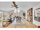 Inviting living room with stone fireplace, hardwood floors, and large windows offering plenty of natural light at 11488 E Amherst S Cir, Aurora, CO 80014