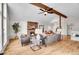 Open concept living room featuring a cozy fireplace, hardwood floors, and comfortable seating at 11488 E Amherst S Cir, Aurora, CO 80014