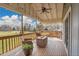 Large covered patio includes wicker furniture, a ceiling fan and a view of the large backyard at 11488 E Amherst S Cir, Aurora, CO 80014