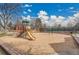 Community playground with a slide, swings, and a large sand area for enjoyment at 11488 E Amherst S Cir, Aurora, CO 80014