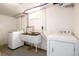 Functional basement laundry area with utility sink, washer, and dryer hookups at 2240 S Clermont St, Denver, CO 80222