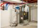 Basement utility area with a modern furnace, water heater, and updated plumbing at 2240 S Clermont St, Denver, CO 80222