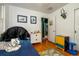 Bedroom with hardwood floors, playful decor, blue bed, and white dresser at 2240 S Clermont St, Denver, CO 80222