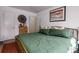 Bedroom with hardwood floors, a decorative dresser, art on the wall, and a comfortable bed at 2240 S Clermont St, Denver, CO 80222