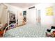 Bright bedroom with hardwood floors, closet, a white bookshelf, and a metal frame bed at 2240 S Clermont St, Denver, CO 80222