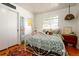 This bedroom features white walls, hardwood floors, closet, and a metal frame bed at 2240 S Clermont St, Denver, CO 80222