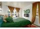Bright bedroom with hardwood floors, large windows, gold curtains, and a comfortable bed at 2240 S Clermont St, Denver, CO 80222