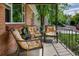 Cozy front porch with comfortable seating and wrought iron railing, perfect for relaxing at 2240 S Clermont St, Denver, CO 80222