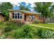 Charming red-brick home with manicured landscaping, bay window, and front porch at 2240 S Clermont St, Denver, CO 80222